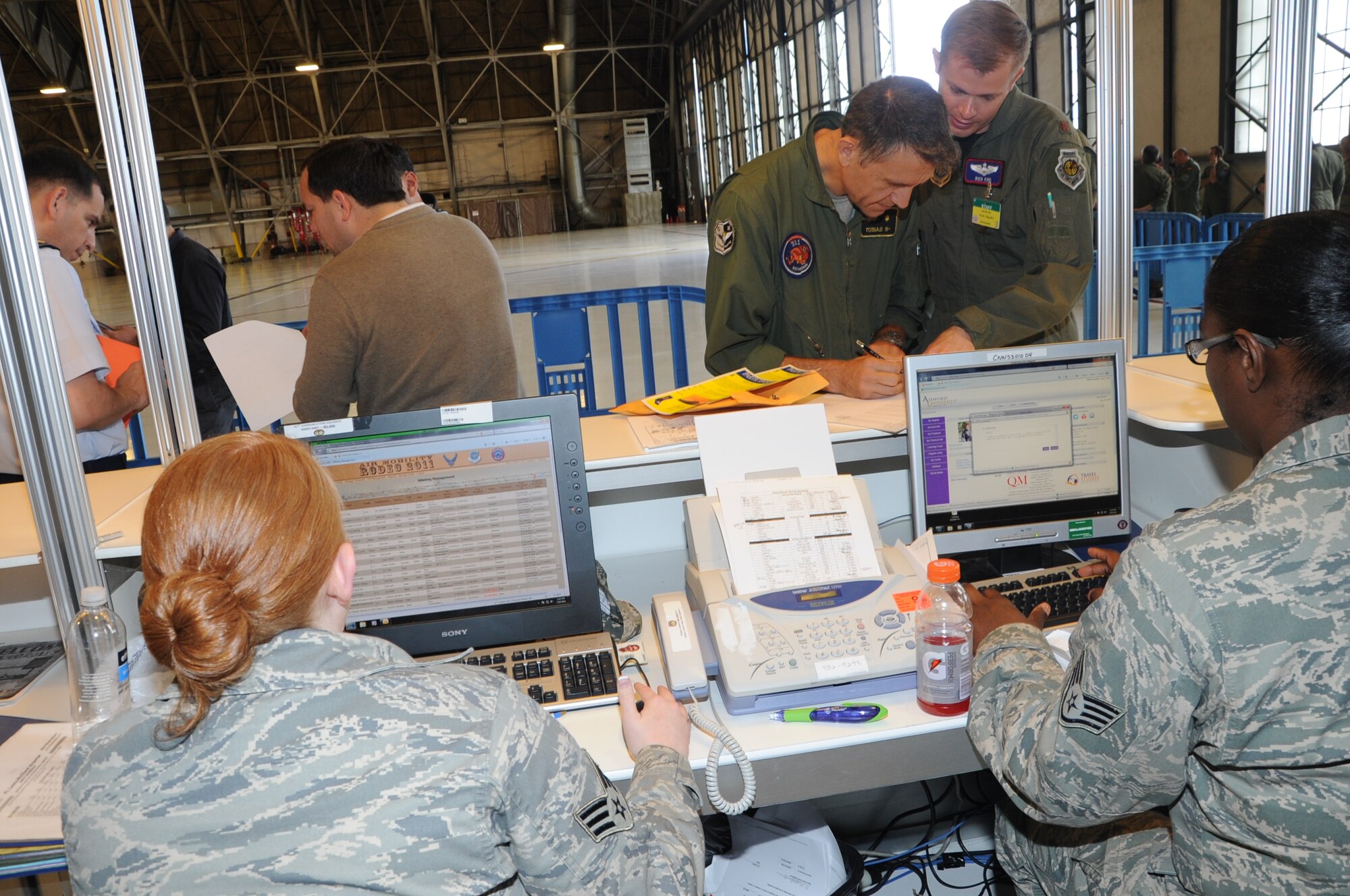 Airmen process through the processing line for Air Mobility Rodeo 2011 at Joint Base Lewis-McChord, Wash., on July 18, 2011. Rodeo is the U.S. Air Force's and Air Mobility Command's premier international combat skills and flying operations competition designed to develop and improve techniques, procedures, and interoperability, while optimizing international mobility  partnerships and enhancing mobility operations. (U.S. Air Force Photo/Tech. Sgt. Christine Jones)