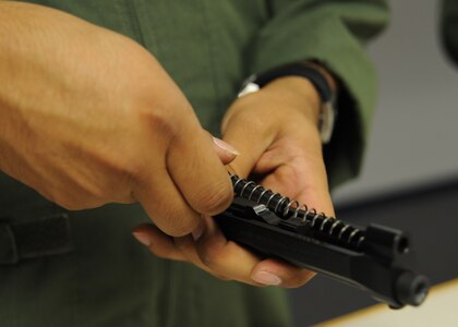 Tech. Sgt. Rafael Chapa puts a reassembles a Beretta M92 pistol during small arms circuit training at Joint Base Charleston July 20. (U.S. Air Force photo/Staff Sgt. Katie Gieratz) 