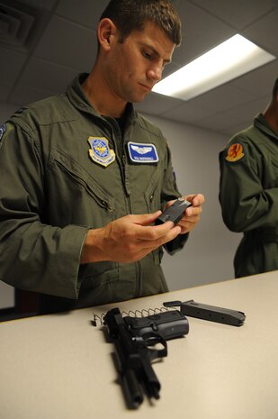 Capt. William McDougall disassembles a Beretta M92 pistol during small arms circuit training at Joint Base Charleston July 20.  McDougall is a pilot with the 17th Airlift Squadron. (U.S. Air Force photo/Staff Sgt. Katie Gieratz) 