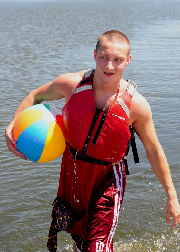 Airman 1st Class Austin Meeks, 28th Communications Squadron network administrator, emerges from Heritage Lake after swimming across it with a blow up beach ball as part of the Ultimate Challenge II: Dine ‘N Dashat Ellsworth Air Force Base, S.D., July 16, 2011. The Airman and Family Readiness Center organized the event to promote camaraderie around Ellsworth. (U.S. Air Force photo/Airman Alystria Maurer/Released)
