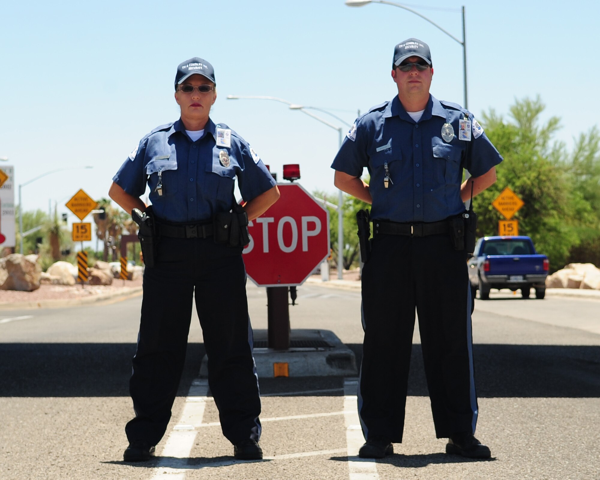 TW & Company Inc. gate guards pose in front of the main gate at Davis-Monthan Air Force Base, Ariz. (U.S. Air Force photo by Airman 1st Class Jerilyn Quintanilla)