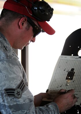 U.S. Air Force Senior Airman Austin Adams, 20th Security Forces combat arms instructor, marks missed points on the target at the small arms training range July 19, 2011. Airmen take the Combat Arms Training and Maintenance class as a requirement for deployments, Permanent Change of Station, or training. (U.S. Air Force photo/Airman 1st Class Tabatha L. Duarte) (Released) 