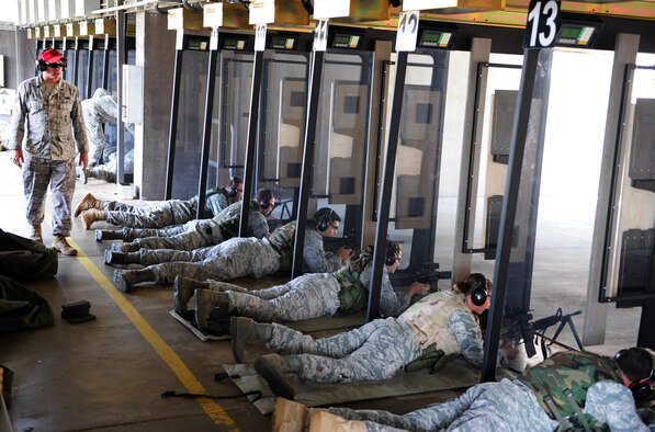 U.S. Air Force Senior Airman Austin Adams, 20th Security Forces combat arms instructor, readies airmen to shoot at their given targets here at the small arms training range July 19, 2011. Airmen take the Combat Arms Training and Maintenance class as a requirement for deployments, Permanent Change of Station, or training. (U.S. Air Force photo/Airman 1st Class Tabatha L. Duarte) (Released) 