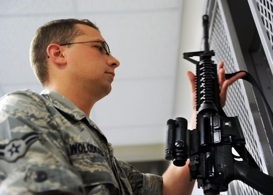 U.S. Air Force Airman 1st Class Nicholas Wolokiewicz, 20th Equipment Maintenance Squadron ammunitions conventional maintainer, picks up his issued M4 carbine at the small arms training range July 19, 2011. Airmen take the Combat Arms Training and Maintenance class as a requirement for deployments, Permanent Change of Station, or training. (U.S. Air Force photo/Airman 1st Class Tabatha L. Duarte) (Released) 