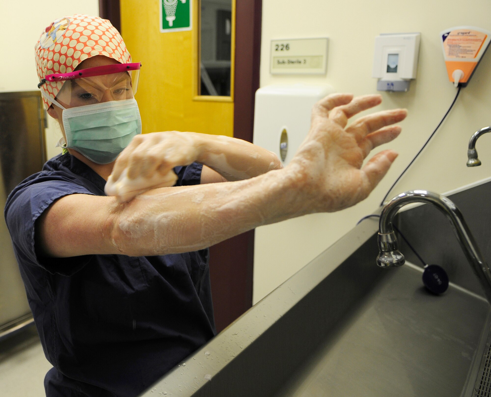 ROYAL AIR FORCE LAKENHEATH, England - Senior Airman Cara Montgomery, 48th Medical Surgical Squadron surgical technician, washes her hands and arms on July 20, 2011. Montgomery was nominated for a Liberty Spotlight because she displays the core value of "Excellence in All We Do".  (U.S. Air Force photo/Staff Sgt. Conner Estes)