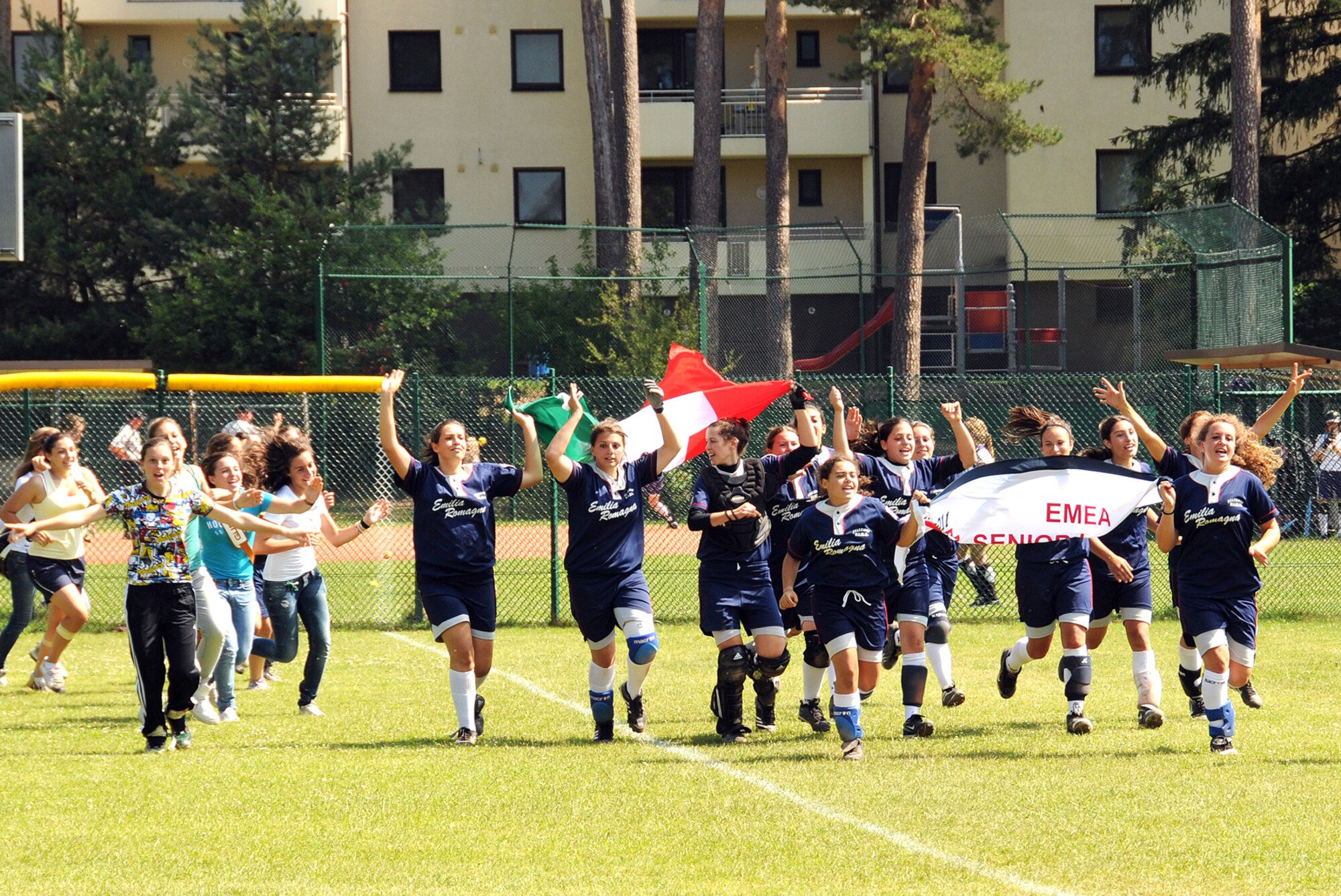 RAMSTEIN AIR BASE, Germany -- The Italian senior softball team runs a victory lap at the Ramstein American High School field after defeating the Netherlands 13-9 July 16 to win the Europe-Middle East-Africa regional tournament and advance to the Little League Softball World Series in the U.S. in August. The regional tournament featured eight teams in junior and senior-level competition. (U.S. Air Force photo by Master Sgt. Jim Fisher)
