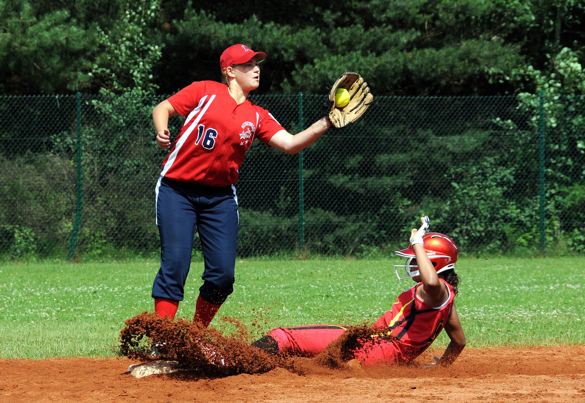 RAMSTEIN AIR BASE, Germany -- KMC Junior third baseman Sabrina Martinez
slides successfully steals second base as Stuttgart second baseman Cosette
Puckett receives the throw from catcher Isabella Capocelli during their game
July 14 here. KMC went on to win 17-10 to advance to the elimination round
of the Europe-Middle East-Africa regional Little League Softball tournament.
Holland went on to win the tournament. (U.S. Air Force photo by Master Sgt.
Jim Fisher)
