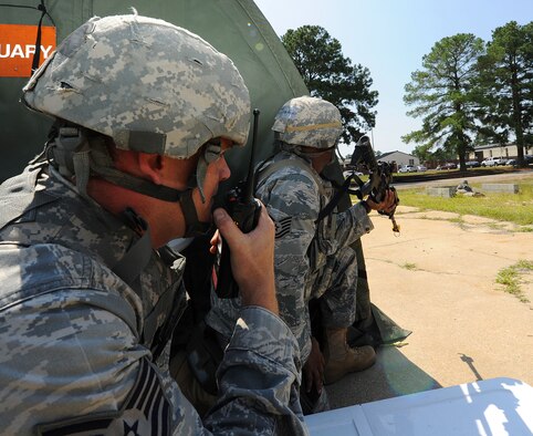 SEYMOUR JOHNSON AIR FORCE BASE, N.C. -- Tech. Sgt. Elmer Smith, 4th Security Forces Squadron flight sergeant, and Tech. Sgt. Don Jones, 4th SFS pass and ID NCOIC, provide simulated quick reaction force support during a Phase II operational readiness exercise here July 19, 2011. The Phase II exercise simulates day-to-day base operations in a combat environment. (U.S. Air Force photo/Senior Airman Gino Reyes)(RELEASED)