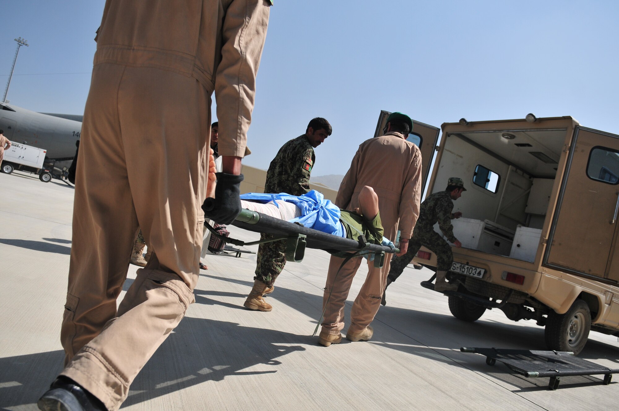 Afghan Air Force Airmen load a wounded Afghan National Army soldier into an awaiting ambulance at the AAF compound in Kabul, Afghanistan. July 20, 2011. The ANA soldiers were flown from Kandahar to Kabul to be treated at the National Military Hospital.  The transfer was the first-ever AAF medical evacuation mission aboard a fixed wing aircraft.  (U.S. Air Force Photo by Tech. Sgt. Brian E. Christiansen)