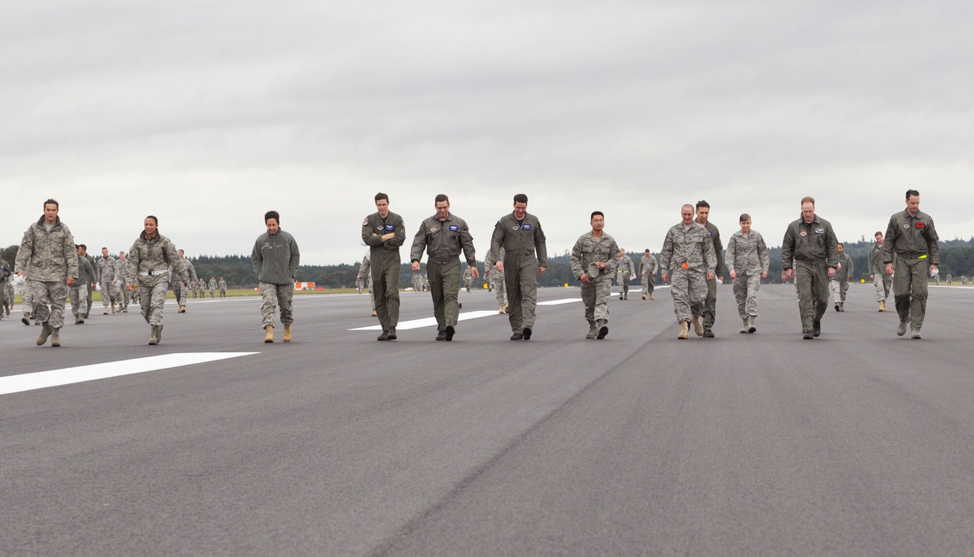 ROYAL AIR FORCE LAKENHEATH, England - Airmen search for foreign objects and debris on the RAF Lakenheath flightline, July 18, 2011. Four groups from various squadrons searched each of the taxiways and runway after construction. The runway closure was part of a three year plan to renovate the entire flightline. It was completed on July 18, 2011.The jets were stationed at RAF Mildenhall for 17 days during the last phase.  (U.S. Air Force photo/Senior Airman Tiffany M. Deuel) 