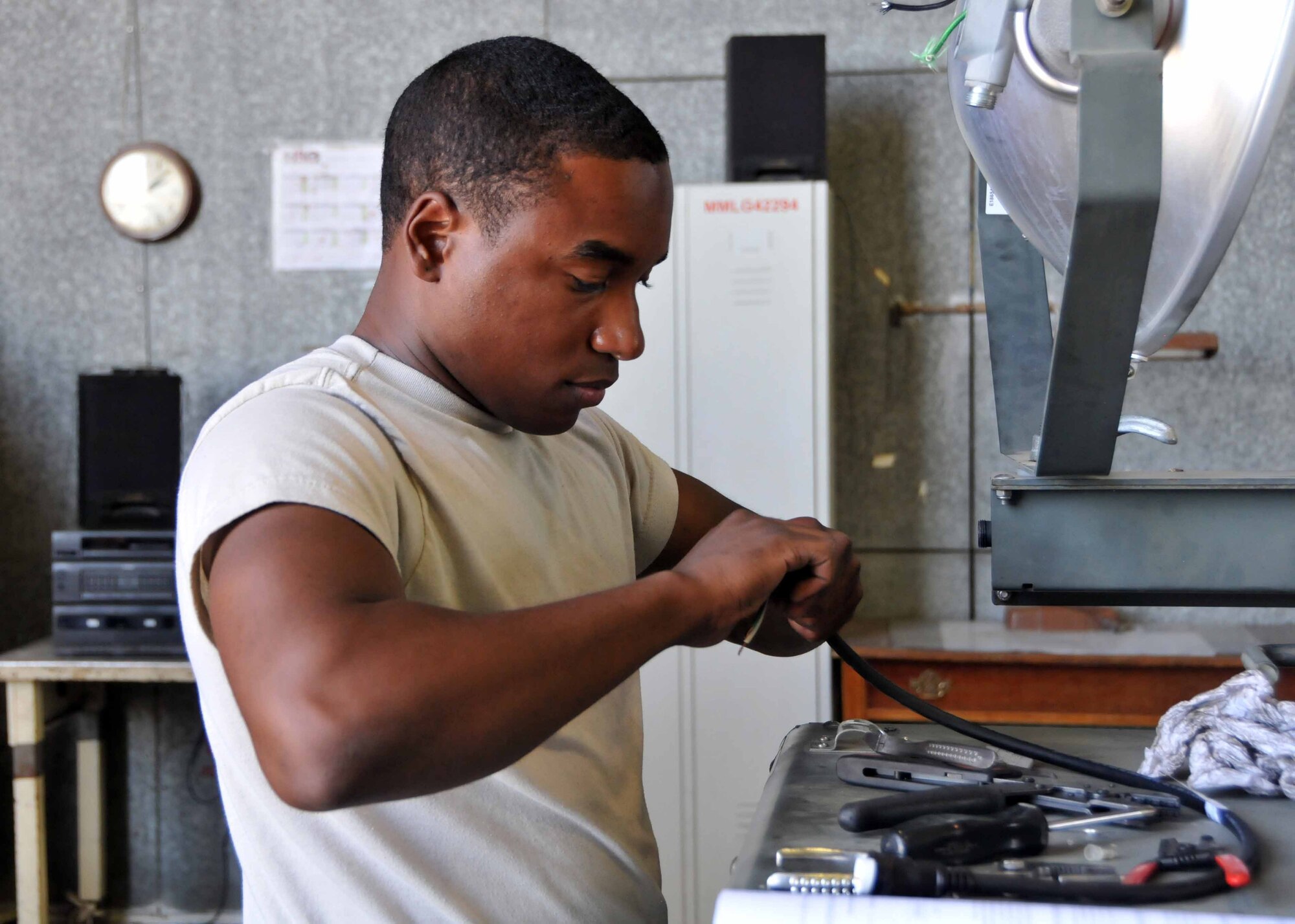 Airman 1st Class Christopher L. Petty, 128th Air Refueling Wing Wisconsin National Guardsman, performs routine maintenance on a light cart while deployed with the 313th Air Expeditionary Wing July 19 in Western Europe. (U.S.  Air Force photo/Capt. John P. Capra)
