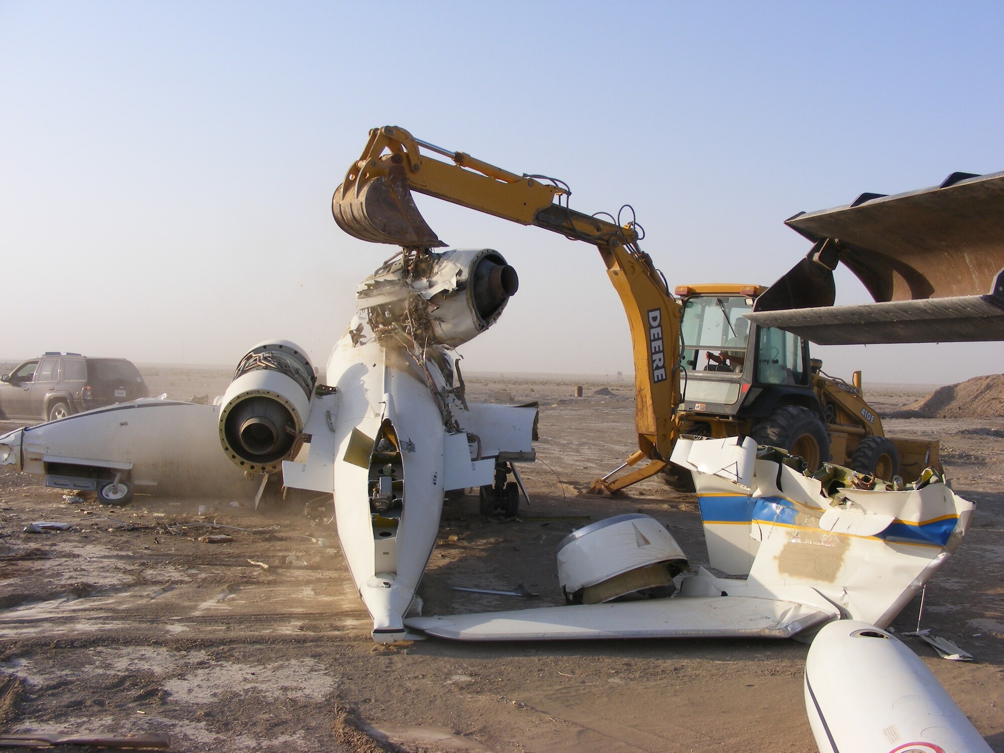 The airframe of a U.S. Air Force C-21 transport plane is disassembled using heavy machinery, prior to its final destruction on 15 July.  The aircraft made a hard langing in 2009, was declared irreparable, and is being demilitarized for disposal.  (Air Force photo by Capt. Jeffrey Davis)