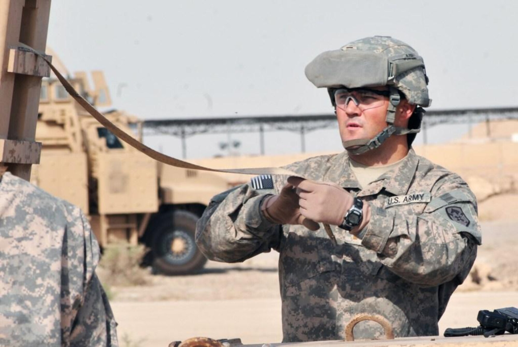 2 nd Lt. William Capps, a logistics officer and platoon leader with the 68th Transportation Company, 749th Combat Sustainment Support Battalion, 4th Sustainment Brigade, 310th Expeditionary Sustainment Command, and a Columbus, Ga., native, secures a pieces of an aircraft that was damaged in 2009, onto a vehicle during a training exercise on Contingency Operating Base Adder, Iraq, July 5. (U.S. Army photo by Pfc. Amy M. Lane)