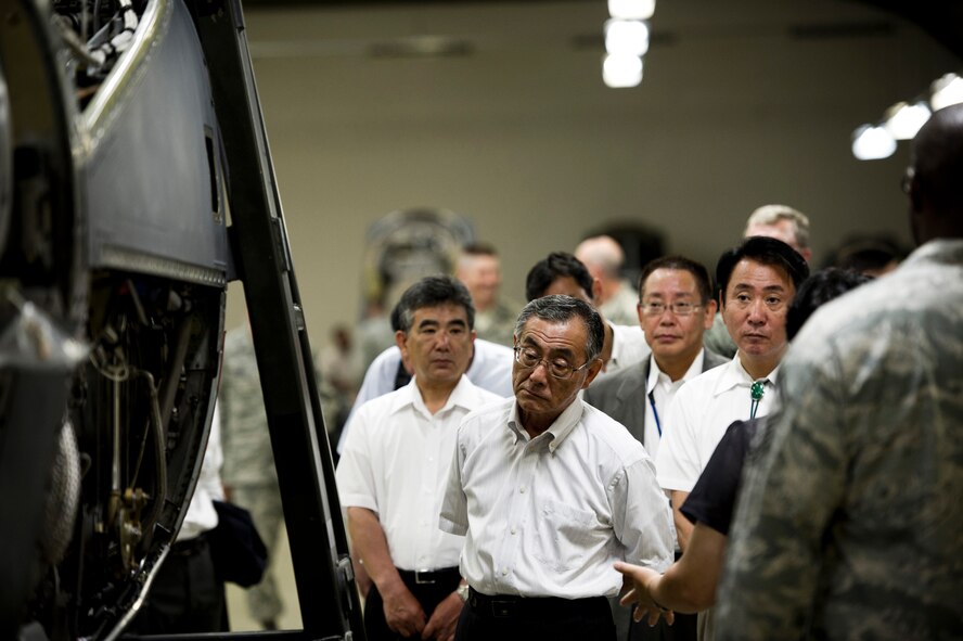 YOKOTA AIR BASE, Japan -- Local dignitaries look at a partially dismantled C-130 Hercules engine during a tour of the engine shop at Yokota Air Base, Japan, July 19, 2011. Each quarter, Yokota hosts vice mayors from the six surrounding communities as well as leaders from the Tokyo Metropolitan Government, North Kanto Defense Bureau and Yokota Defense Office to discuss local concerns and strengthen ties between the base and its neighbors. (U.S. Air Force photo/Staff Sgt. Samuel Morse)