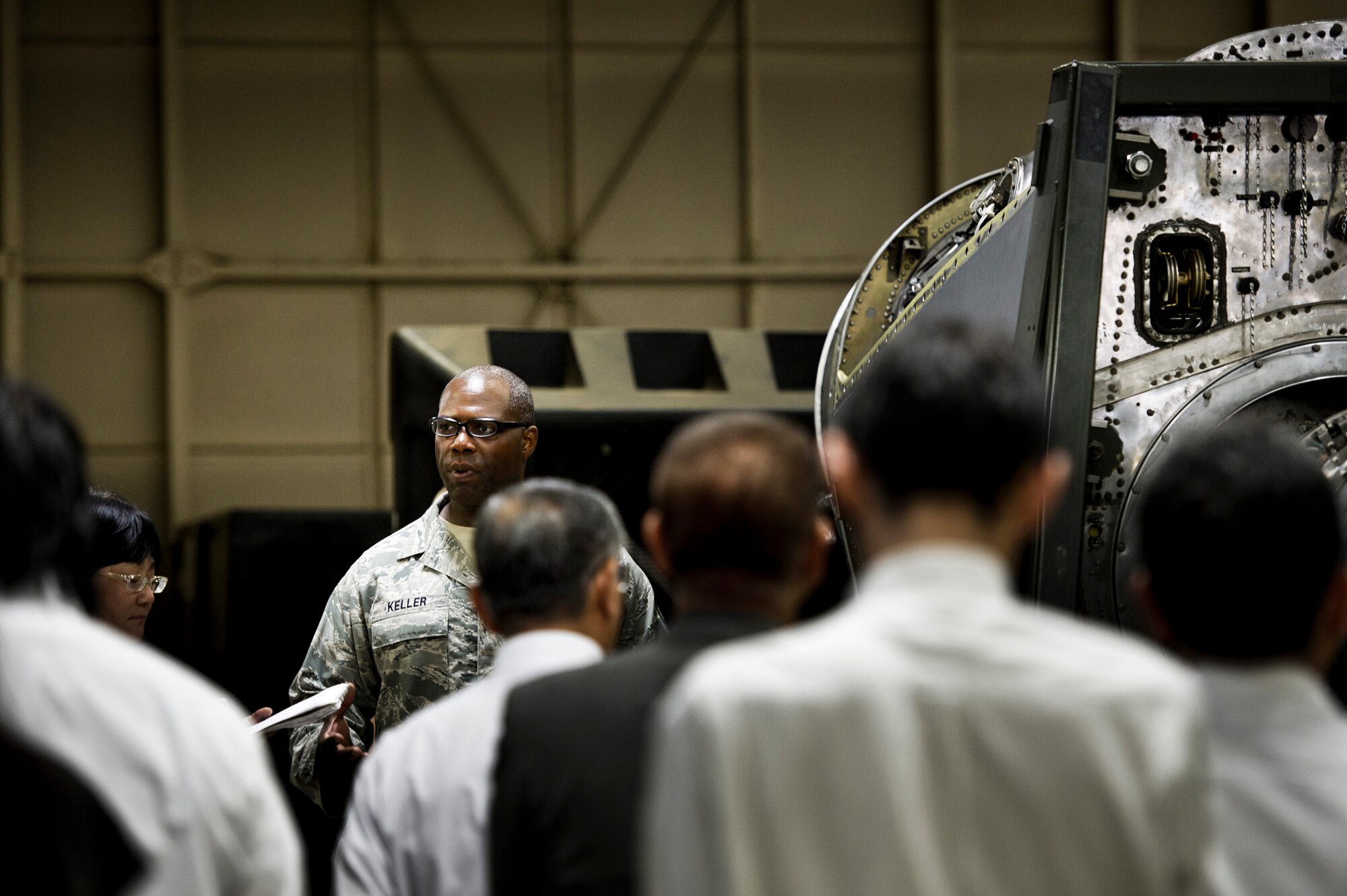YOKOTA AIR BASE, Japan -- Senior Master Sgt. David Keller, 374th Maintenance Squadron Propulsion Flight chief, talks to a group of local dignitaries visiting Yokota Air Base, Japan, July 19, 2011. Each quarter, Yokota hosts vice mayors from the six surrounding communities as well as leaders from the Tokyo Metropolitan Government, North Kanto Defense Bureau and Yokota Defense Office to discuss local concerns and strengthen ties between the base and its neighbors. (U.S. Air Force photo/Staff Sgt. Samuel Morse)