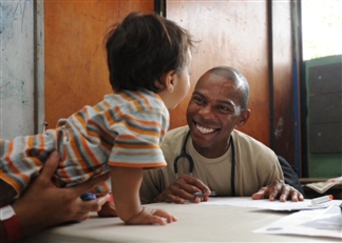 U.S. Air Force Capt. Chuck Henderson (right) interacts with a patient at the Instituto Nacional de Acajutla medical site in Acajutla, El Salvador, during Continuing Promise 2011 on July 17, 2011.  Continuing Promise is a regularly scheduled mission to countries in Central and South America and the Caribbean, where the U.S. Navy and its partnering nations work with host nations and a variety of governmental and nongovernmental agencies to train in civil-military operations.  