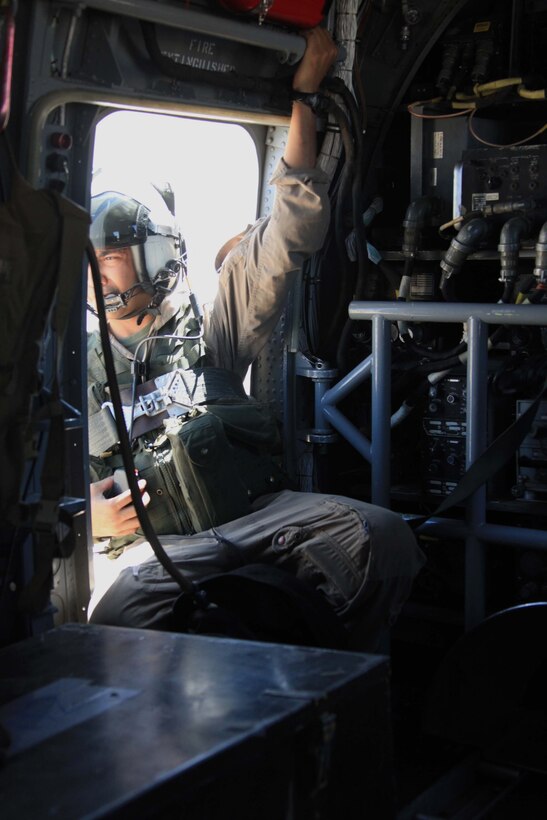 Sgt. Cedric V. Ruffin, HMM-764 crew chief, looks out the side of a CH-46 during a tactical insertion training exercise at Marine Corps Air Station Yuma, Ariz., July 20, 2011. The exercise was one of many performed during Operation Javelin Thrust 2011 to prepare reserve Marines for deployment.