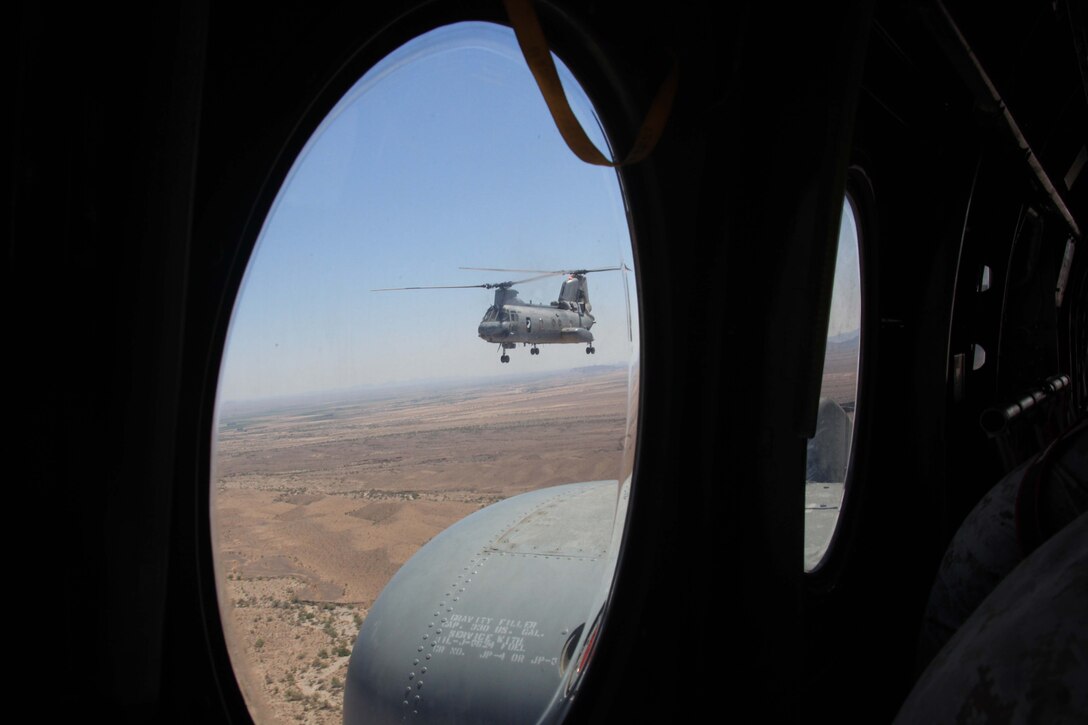 A CH-46 Sea Knight flies alongside another CH-46 in a tactical insertion exercise at Marine Corps Air Station Yuma, Ariz., July 20, 2011. In the training exercise, reconnaissance Marines fast-roped out of the CH-46 to simulate the small area insertions the helicopter can perform.