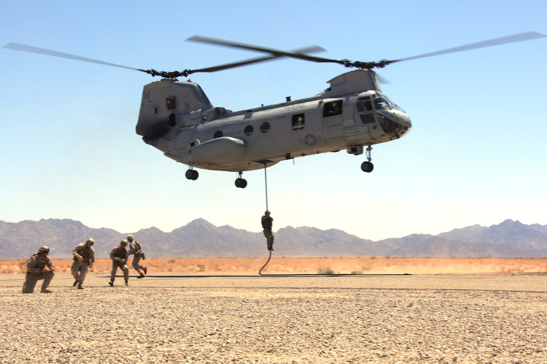 The 3rd Reconnaissance Company Marines fast-rope out of a CH-46 and provide cover during a tactical insertion exercise at Marine Corps Air Station Yuma, Ariz., July 20, 2011. The fast-roping exercise was one of many training exercises taking place during Operation Javelin Thrust 2011.