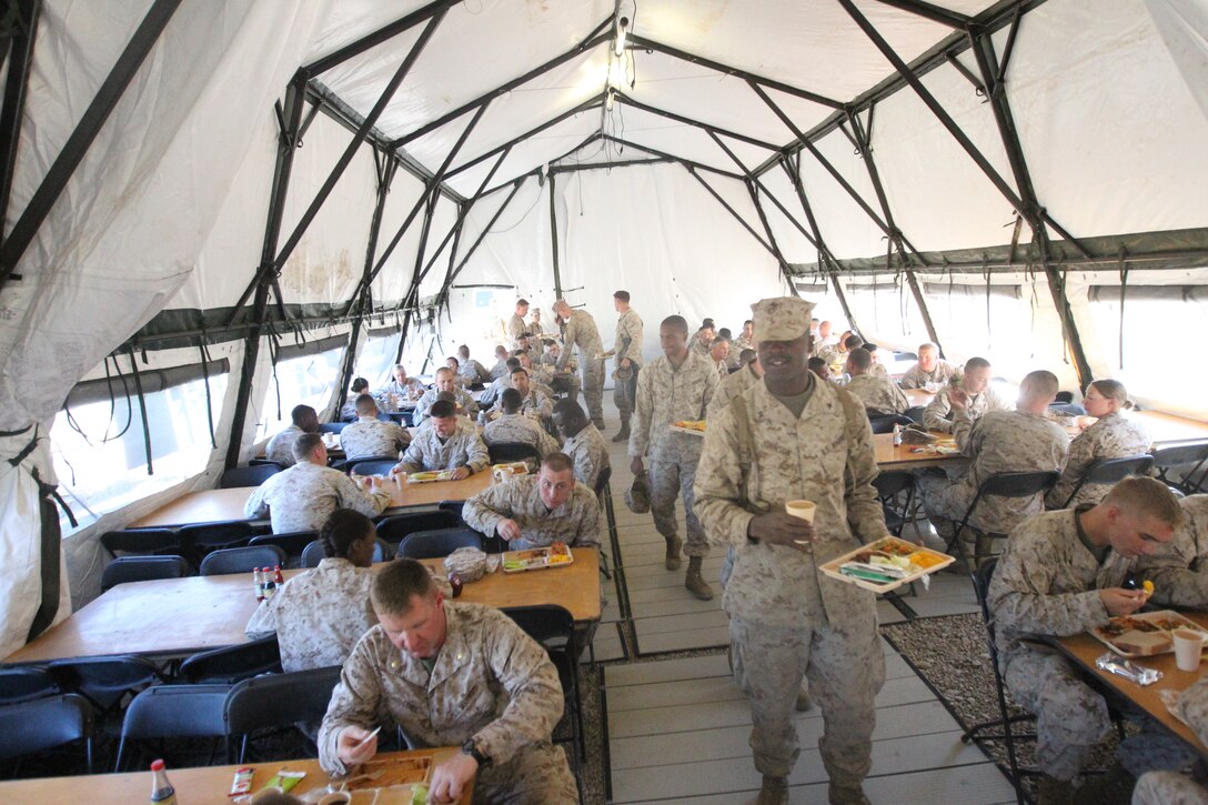 Marines and sailors enjoy their evening meal provided by reserve and active duty food specialists, July 20. The service members are participating in Operation Javelin Thrust at Marine Corps Mountain Warfare Training Center.