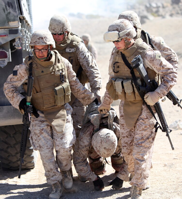 Marines with Combat Logistics Battalion 1, Combat Logistics Regiment 1, 1st Marine Logistics Group, carry a simulated casualty to safety during a first responder causality exercise at Marine Corps Air Ground Combat Center Twentynine Palms, Calif., July 20.  Marines with Combat Logistics Battalion 1, Combat Logistics Regiment 1, 1st Marine Logistics Group, trained alongside Marines from 1st Marine Division in order to gain more experience in applying first-aid.