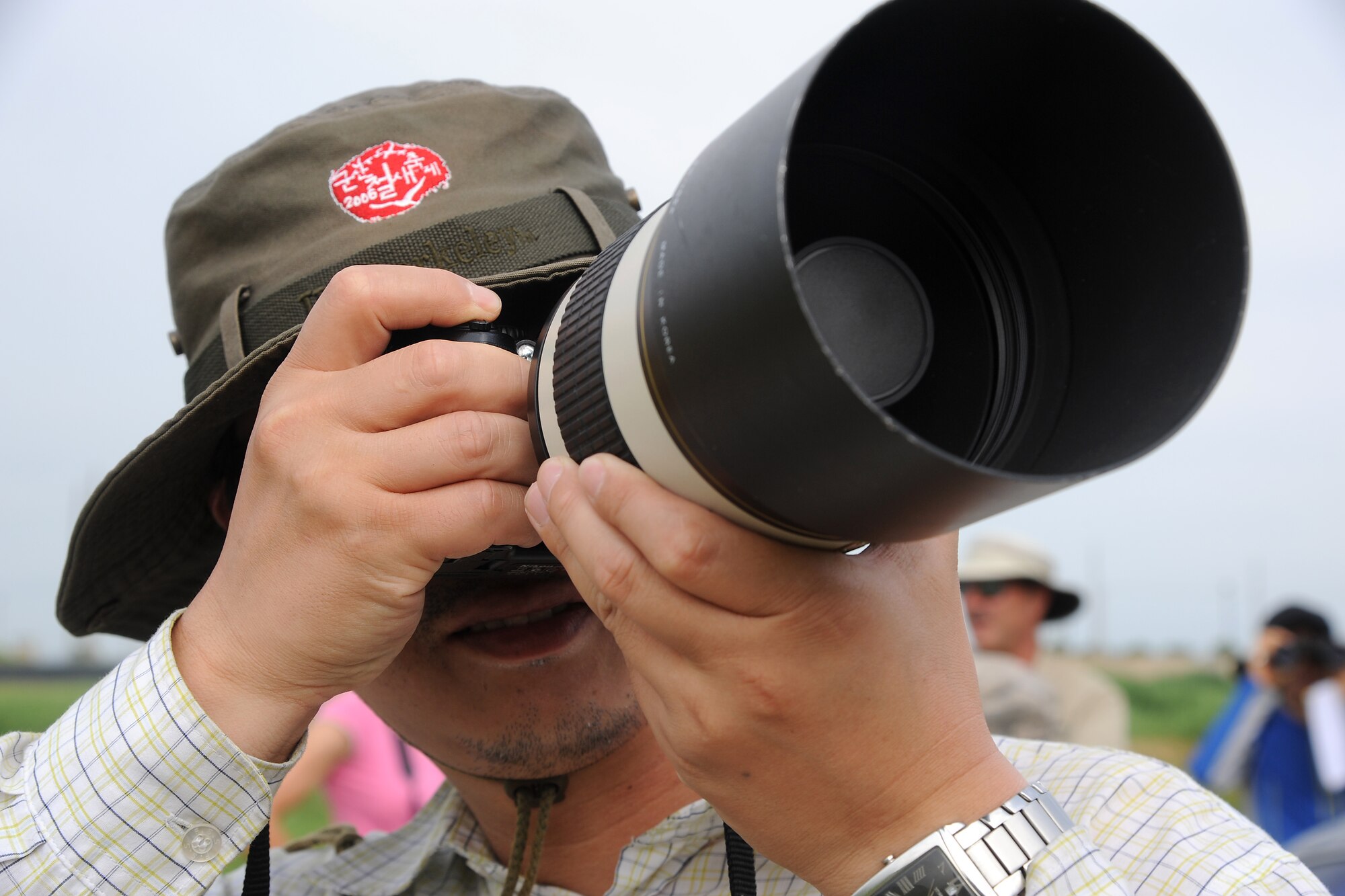 KUNSAN AIR BASE, Republic of Korea -- Suk Kyu Kim, a biology doctorate student at Kunsan National University in Gunsan City, takes photographs for a migratory avian survey being held here July 21. (U.S. Air Force photo/Staff Sgt. Rasheen A. Douglas)