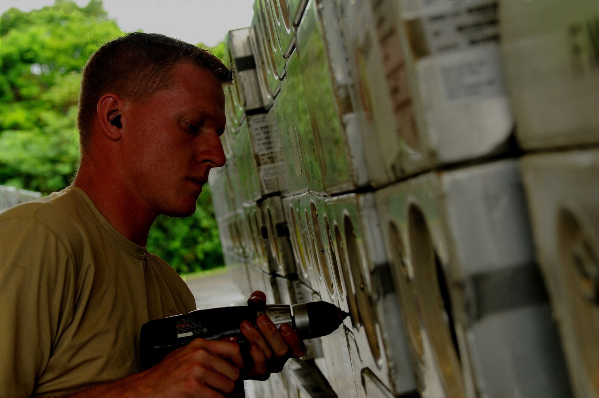 Airman 1st Class Trevor Mortensen, 18th Munitions Squadron conventional maintenance crew chief, performs a time compliance technical order on a munitions computer firmware during a field training exercise at Kadena Air Base, Japan, July 13. Mortensen is a native of Edmond, Oklahoma and has been assigned to Kadena for more than three years. (U.S. Air Force photo/Airman 1st Class Jarvie Z. Wallace)
