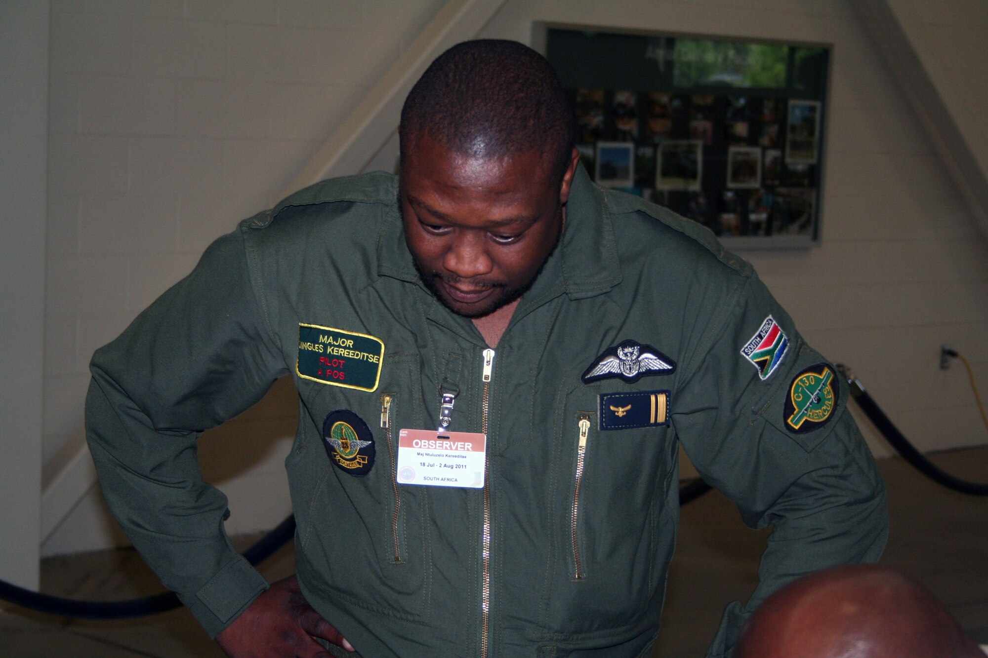 Maj. Ntuluzelo Kereeditse of the South Africa air force observes parachute riggers pack a parachute at the 62nd Aerial Port Squadron aerial delivery facility July 21, 2011, at Joint Base Lewis-McChord, Wash. Kereeditse was one of several participants from five African nations in the 2011 International Airdrop Symposium July 19-21, 2011. (U.S. Air Force Photo/Master Sgt. Scott T. Sturkol)