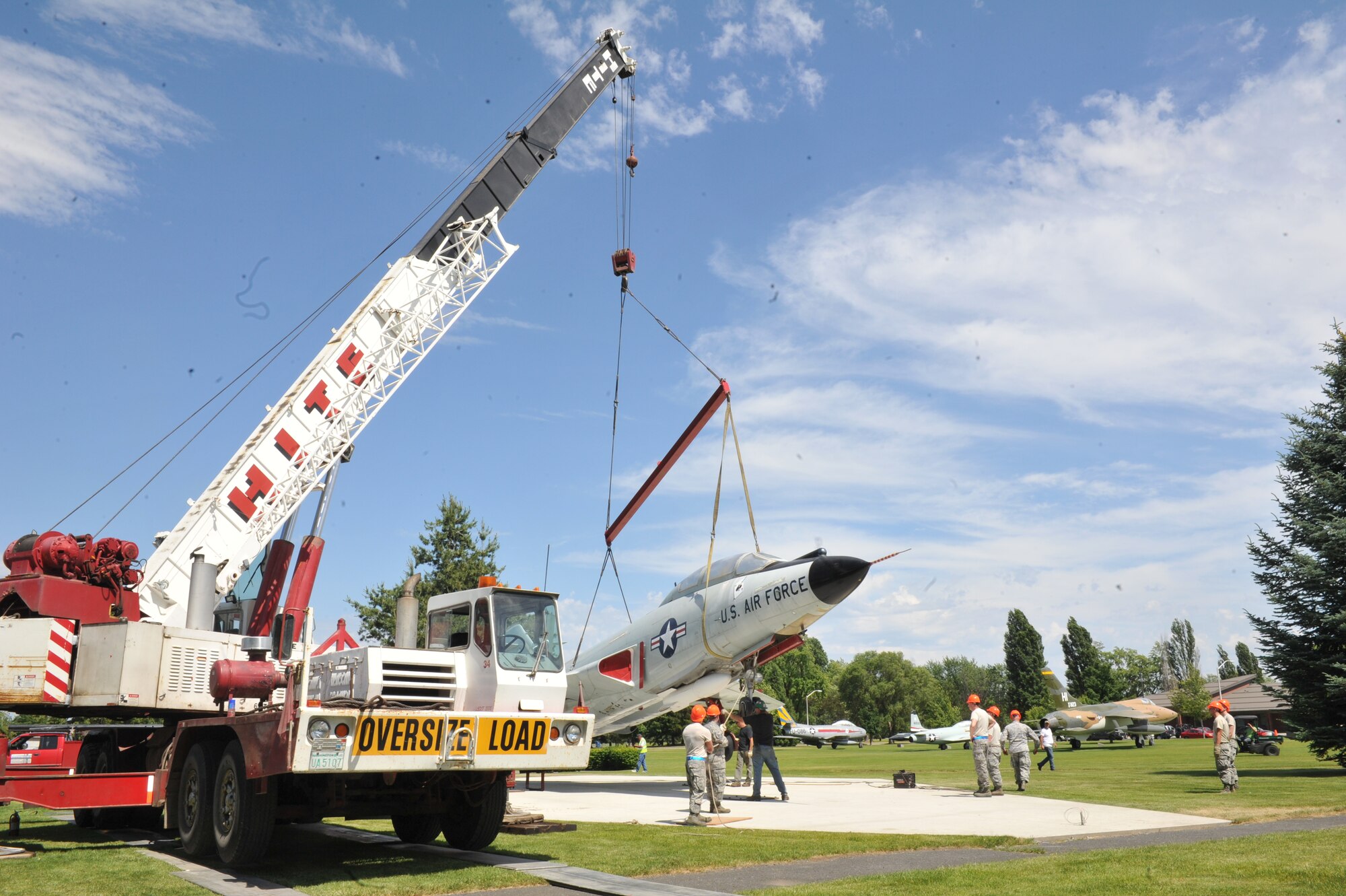In an effort to make the Fairchild Air Park more aesthetically pleasing and functional, an F-101 is hoisted into the air via crane into its new home July 8.  (U.S. Air Force photo/Tech. Sgt. JT May III)