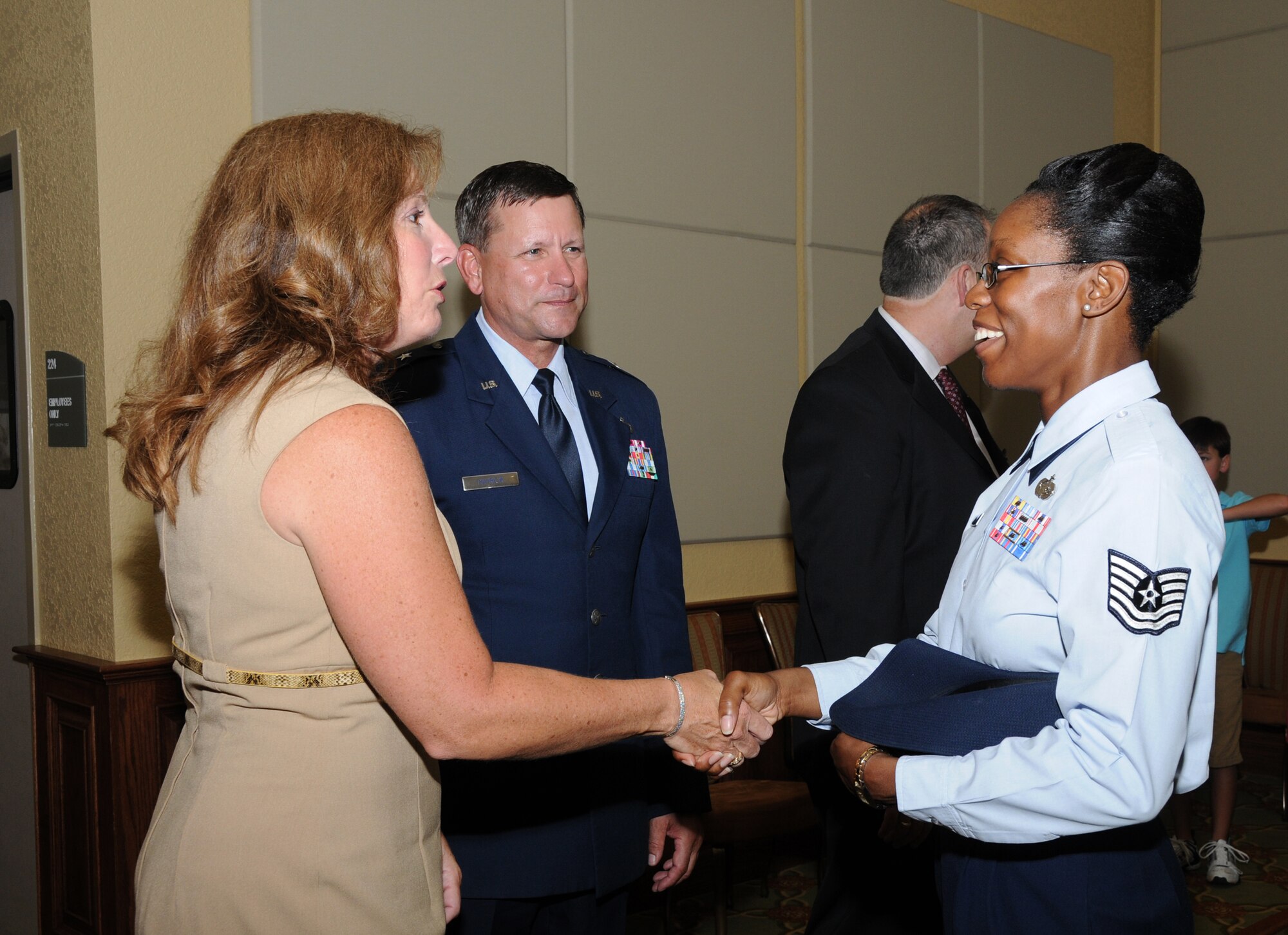 From left, Lynn and Brig. Gen. Leonard Patrick, new 2nd Air Force commander, meets one of his new staff members, Tech. Sgt. Tanya Boyd, at a reception at the Bay Breeze Event Center following the change of command ceremony July 21 at Keesler Air Force Base, Miss.  Patrick previously commanded the 502nd Air Base Wing at Fort Sam Houston, Texas.  He replaces Maj. Gen. Mary Kay Hertog, who’s headed to the Pentagon to direct the Department of Defense Sexual Assault Prevention and Response Office.  (U.S. Air Force photo by Kemberly Groue)