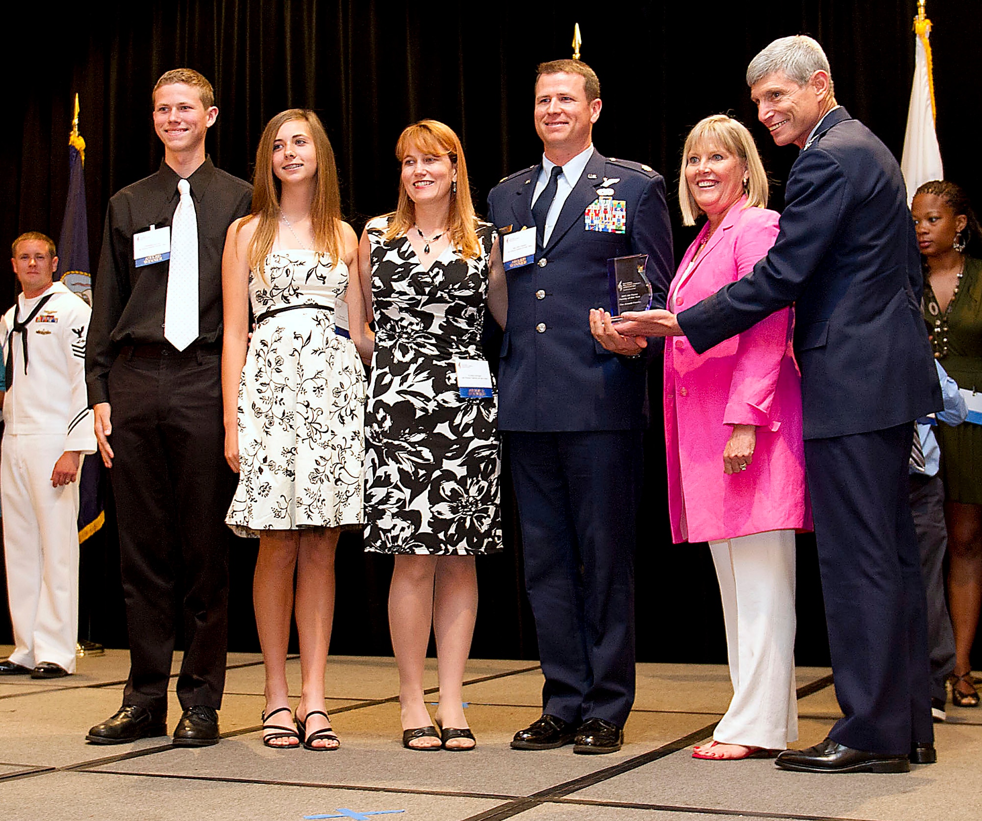 Air Force Chief of Staff Gen. Norton Schwartz and his wife Suzie (second from right) congratulate the Arnold family for being recognized as the National Military Family Association's Air Force Family of the Year during a luncheon July 21, 2011, in Arlington, Va. National Military Family Association officials chose the Arnold family, consisting of Maj. Eric Arnold, his wife Cristie, and their children Christian, Cierra and Conner (not pictured), for their commitment to community service. The Arnolds are stationed at Dyess Air Force Base, Texas. The association recognized families from each of the uniformed services, including the U.S. Public Health Service. (U.S. Army photo/Myles Cullen)