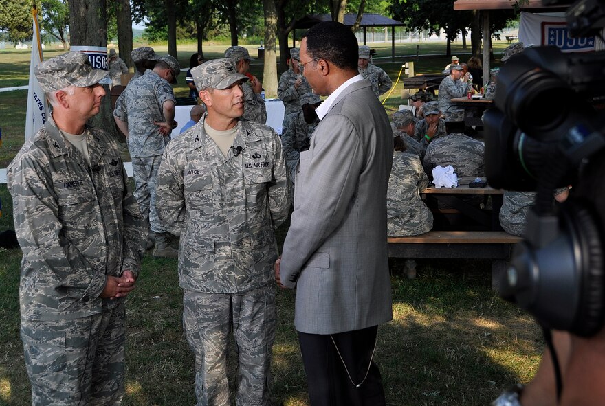 Col. Mark D. Camerer, 436th Airlift Wing commander, and Col. Thomas C. Joyce, Air Force Mortuary Affairs Operations commander, give a live interview to CBS 3 Philadelphia news anchor Ukee Washington during Eyewitness News at 5 at the Star Spangled Barbecue hosted by USO Delaware and CBS 3. (U.S. Air Force photo/Staff Sgt. Agustin Salazar)