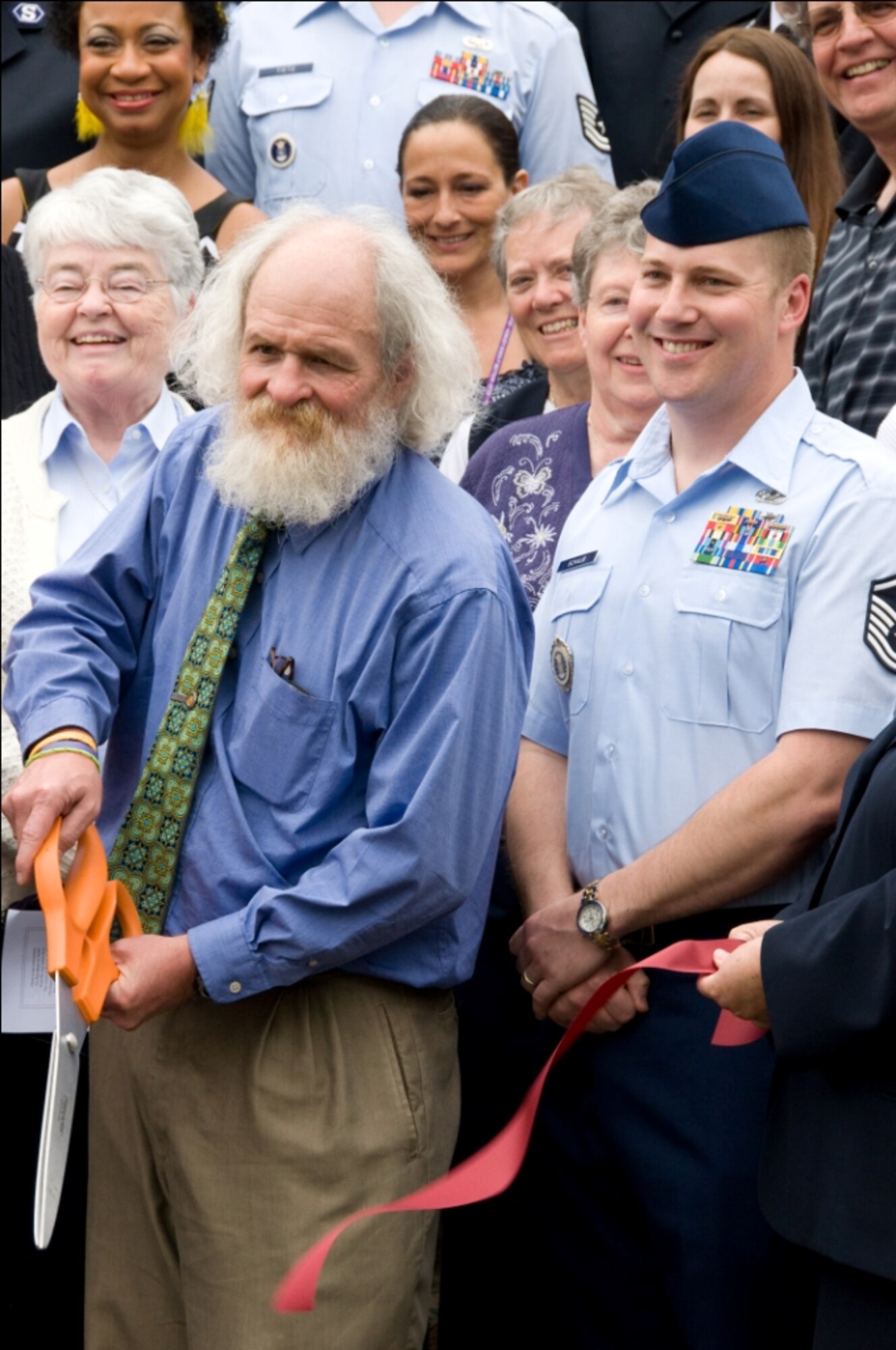 Mr. Rick Stroller, The Salvation Army program director, and Master Sgt. Ben Schaub, 361st Recruiting Squadron D-Flight flight chief, cut the ribbon to a veteran’s homeless shelter June 22 in Beaverton, Ore. The shelter was refurbished with the help of 15 Airmen from the 361st RCS. (U.S. Air Force photo/courtesy photo)