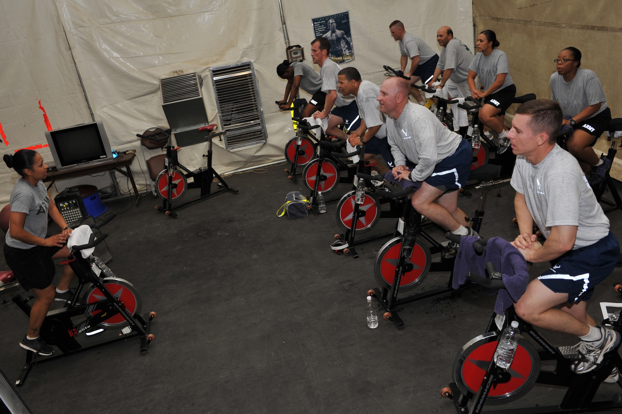 U.S. Army Sgt. Jessica Recinos, 22nd Human Resources Company, rest and relaxation customer service representative and passenger terminal clerk, motivates participants of a cycling spin class, Sather Air Base, Iraq, July 19, 2011. Recinos volunteers her evenings leading the class to give troops a fun way to stay in shape. Recinos is deployed from Joint Base Lewis-McChord, Wash. and hails from Santa Anna, Calif. (U.S. Air Force photo/Tech. Sgt. Josef Cole)


