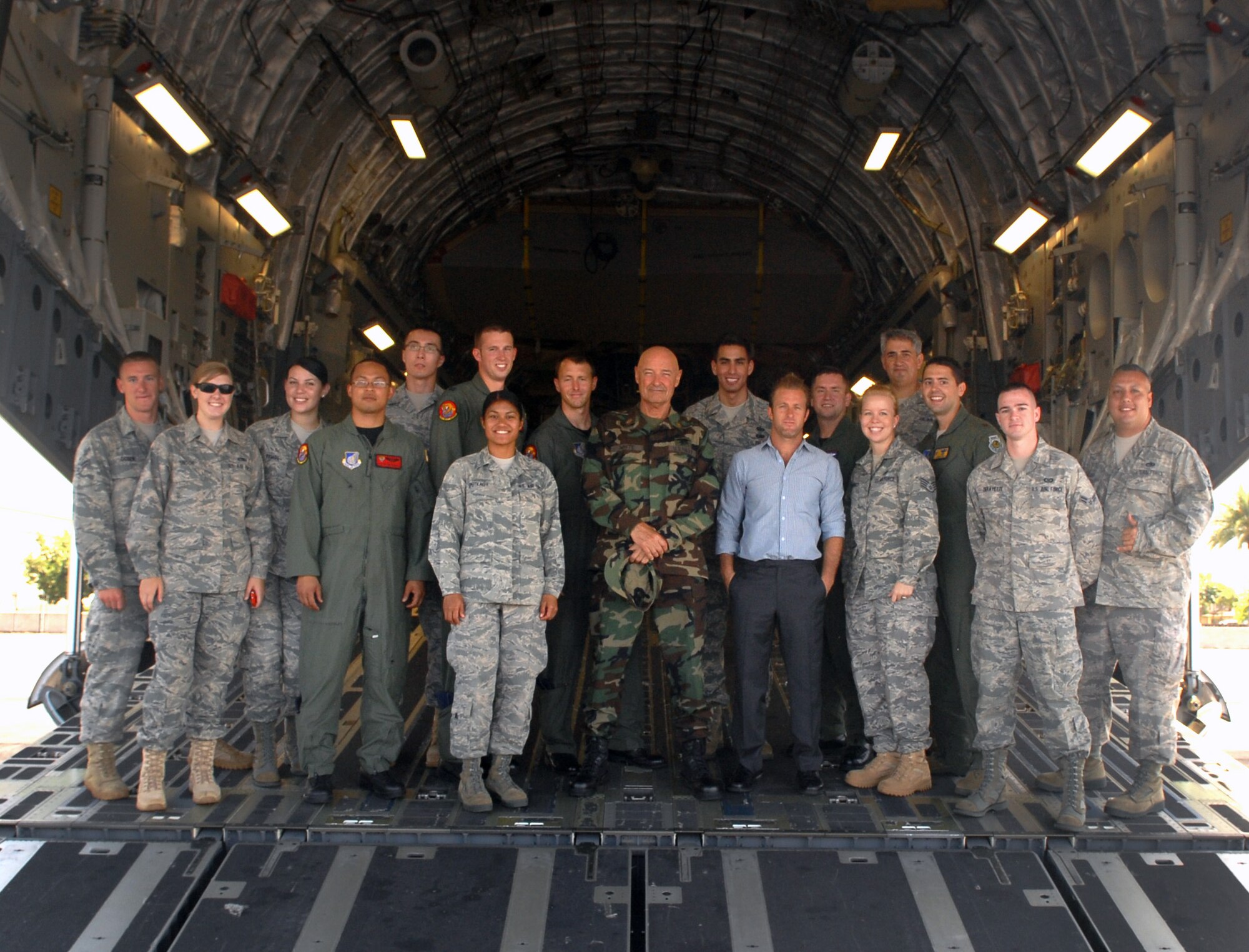 Airmen pose with talent from "Hawaii Five-0" inside a 15th Wing C-17 at Joint Base Pearl Harbor-Hickam, Hawaii, July 20. "Hawaii Five-0" filmed a portion of an upcoming episode here, and the 10 Airmen who participated now have a chance to be in the final shots. (U.S. Air Force photo/Staff Sgt. Carolyn Herrick)
