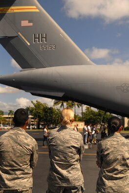 JOINT BASE PEARL HARBOR-HICKAM, Hawaii -- Airmen from Joint Base Pearl Harbor-Hickam watch as "Hawaii Five-0" films a portion of an upcoming episode on the flight line July 20. Ten Airmen participated in the shoot, doing their day-to-day jobs, and now have a chance to be in the final shots. This is the second year the hit CBS show has filmed at Hickam. (U.S. Air Force photo/Staff Sgt. Carolyn Herrick)
