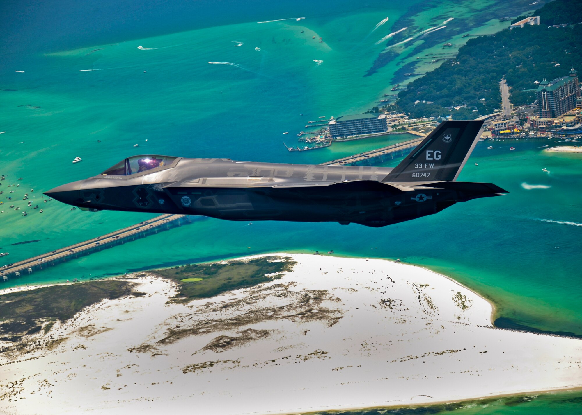 An F-35 Lightning II flies over Destin, Fla., before landing at its new home at Eglin Air Force Base, Fla., July 14, 2011. Its pilot, Lt. Col. Eric Smith is the first Air Force qualified F-35 pilot and is assigned to the 58th Fighter Squadron. (U.S. Air Force photo/Staff Sgt. Joely Santiago)

