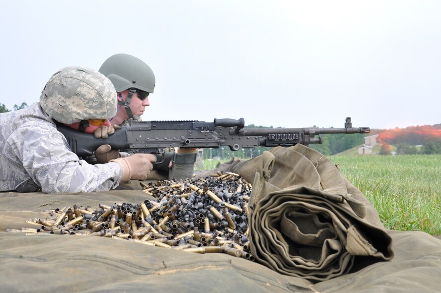 WRIGHT-PATTERSON AIR FORCE BASE, Ohio – Tech. Sgt. Thomas Lakes, 445th Security Forces Squadron, fires an M-240 machine gun while his assistant gunner, fellow squadron member Staff Sgt. Steven Wright, feeds him ammunition during their annual tour at Fort Knox, Ky., June 4. (U.S. Air Force photo by Tech. Sgt. Jeremy Caskey)