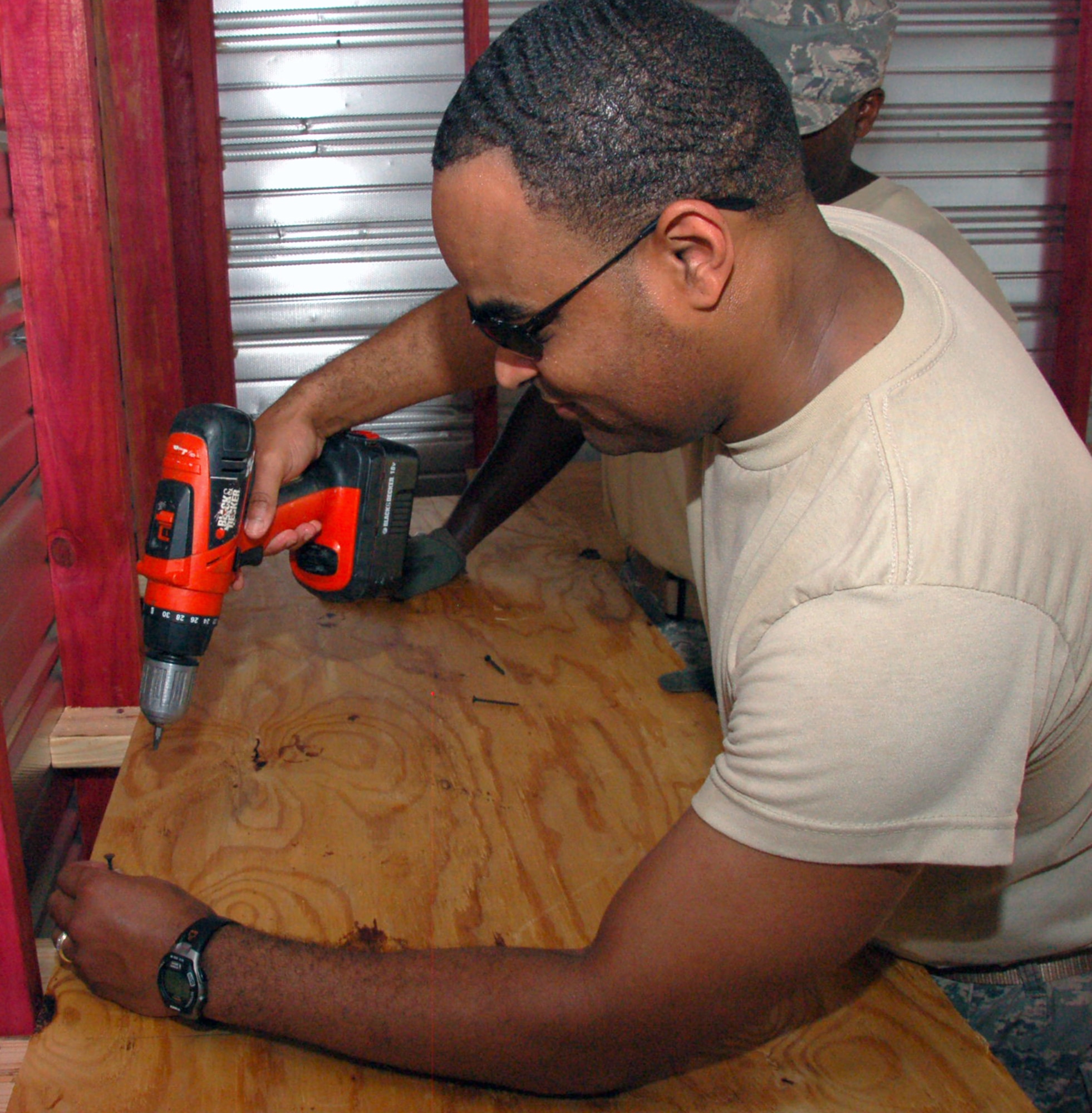 SHREVEPORT, La. – Chief Master Sgt. Keith Bailey, Headquarters Eighth Air Force, secures a plywood shelf in the Providence House daycare storage area.  Fourteen members of the Headquarters Eighth Air Force staff and 608th Air Operations Center volunteered their time to help the Providence House in downtown Shreveport, La., July 20. The members were built new shelves for the daycare and moved furniture in the warehouse. The Providence House is a residential development center for homeless families with children, providing comprehensive support services for improving the family structure and moving the family into independent living. (U.S. Air Force photo by Staff Sgt. Brian Stives)