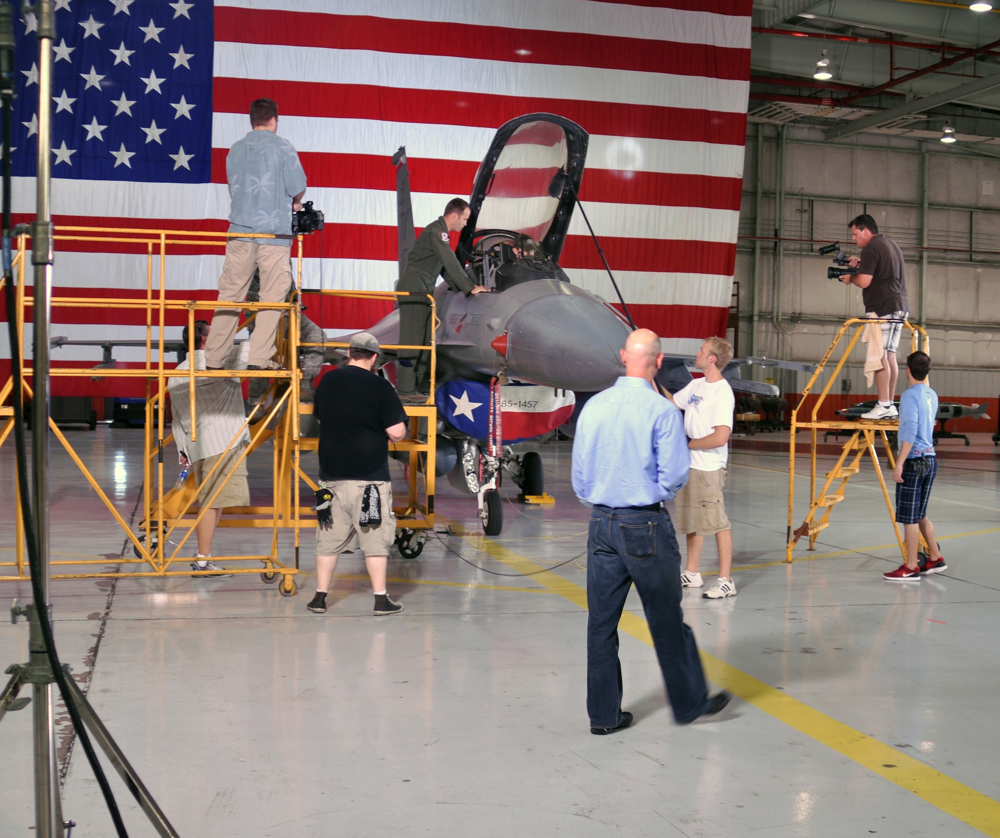 A video-production crew films Maj. Mike Barron and American Idol winner Scotty McCreery in an F-16C Fighting Falcon July 20 at the 301st Fighter Wing, NAS Fort Worth JRB, TX.  Major Barron is an Air Force Reserve F-16 pilot in the 457th Fighter Squadron.  The production crew was filming a public-service announcement for the Air Force Reserve Command Recruiting Service.  (U.S. Air Force photo/Lt. Col. David Kurle)