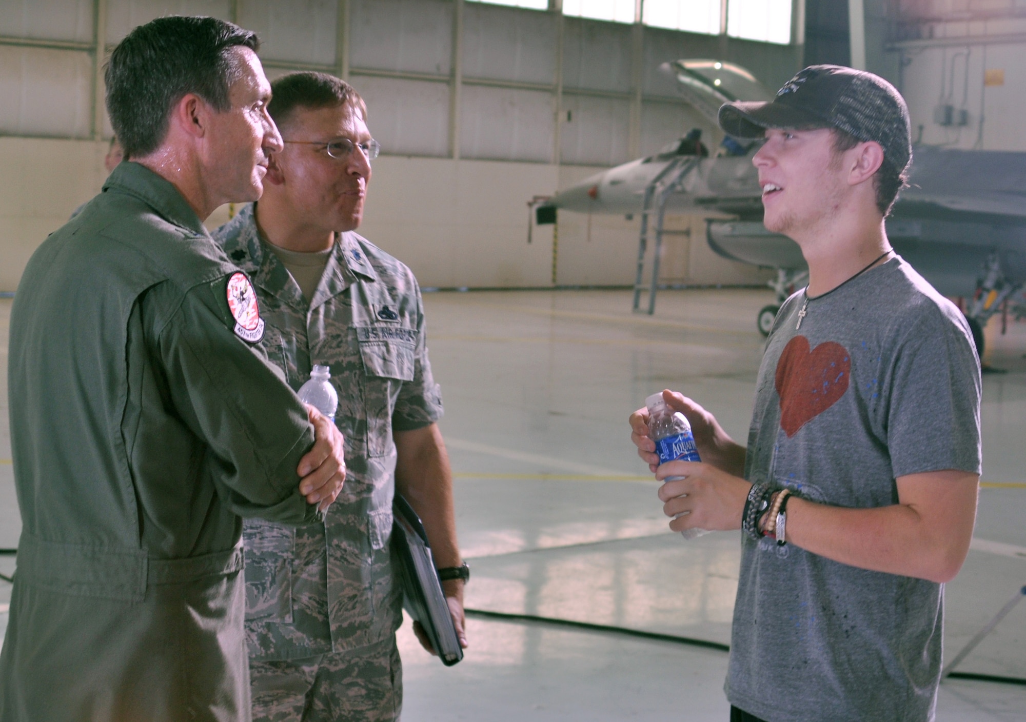 Brig. Gen. Bruce Miller, left, and Lt. Col. Max Stitzer, center, chat with 2011 American Idol winner Scotty McCreery during a break in filming an advertisement for Air Force Reserve Command Recruiting Service July 20 at the 301st Fighter Wing, based at NAS Fort Worth JRB, Texas.  General Miller is the 301st FW commander and Colonel Stitzer is the commander of the 301st Maintenance Group.  (U.S. Air Force photo/Lt. Col. David Kurle)