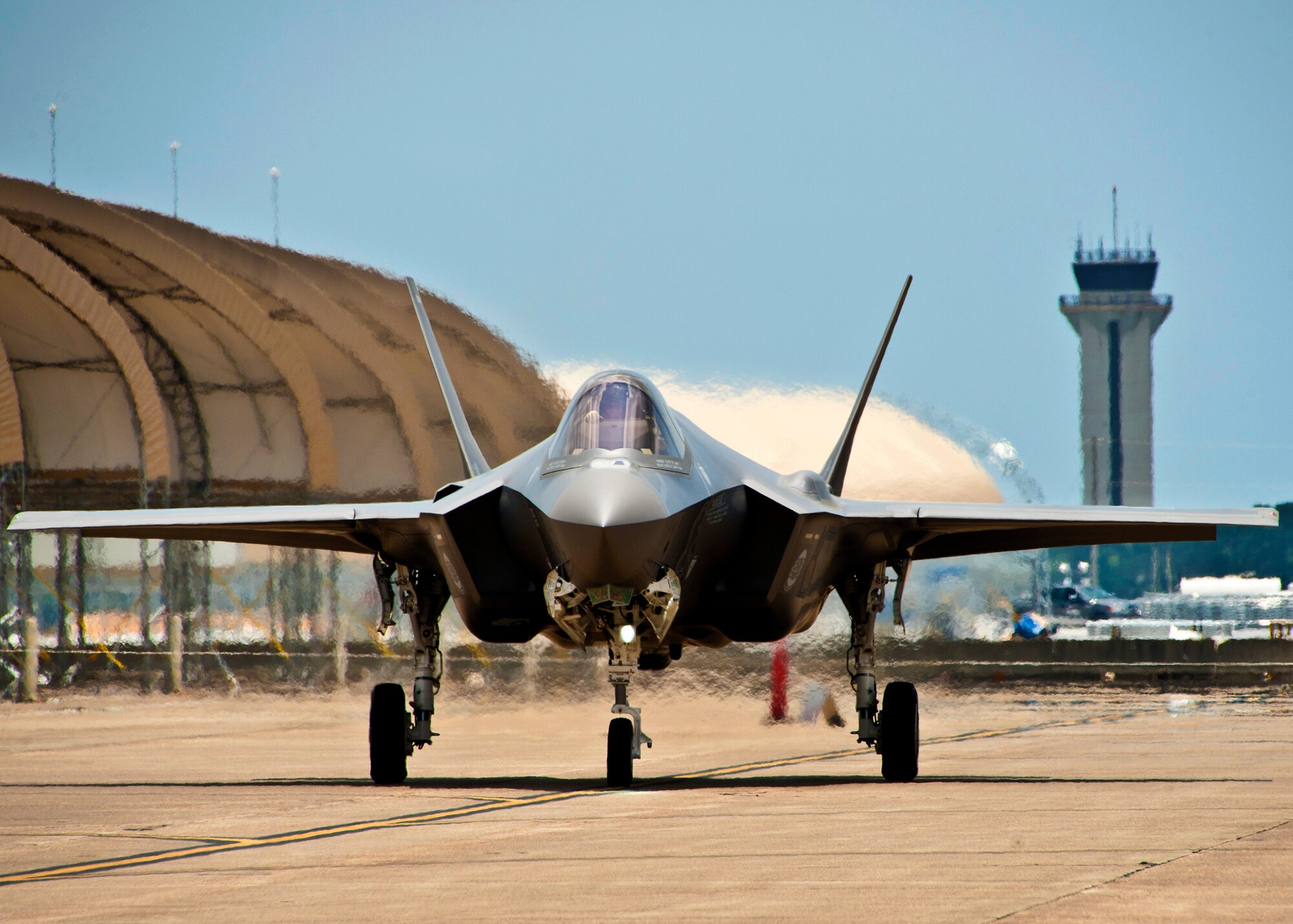 Marine Maj. Joseph Bachmann, of the 33rd Operations Group, brings the second F-35 Lightning II joint strike fighter down the taxiway to its new home at Eglin Air Force Base, Fla., July 20.  Bachmann is the first Marine pilot to be JSF certified.  Aircraft AF-8 is the flagship for the 58th Fighter Squadron.  (U.S. Air Force photo/Samuel King Jr.)