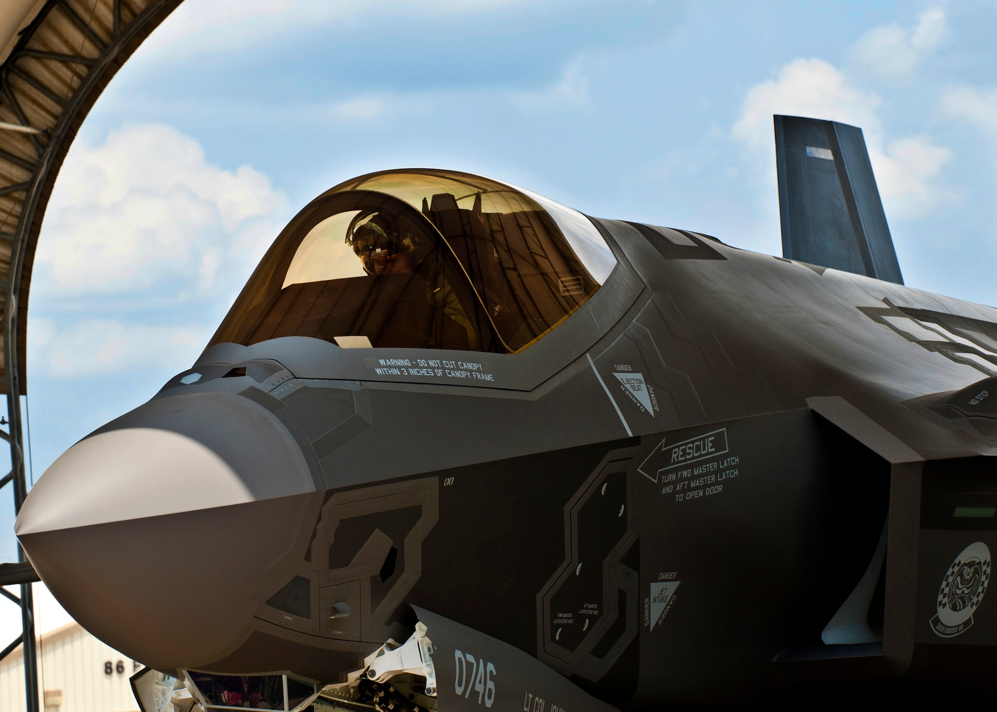 Marine Maj. Joseph Bachmann, of the 33rd Operations Group, executes aircraft shutdown procedures on the second F-35 Lightning II joint strike fighter to arrive at Eglin Air Force Base, Fla., July 20.  Bachmann is the first Marine pilot to be JSF certified.  Aircraft AF-8 is the flagship for the 58th Fighter Squadron.  (U.S. Air Force photo/Samuel King Jr.)