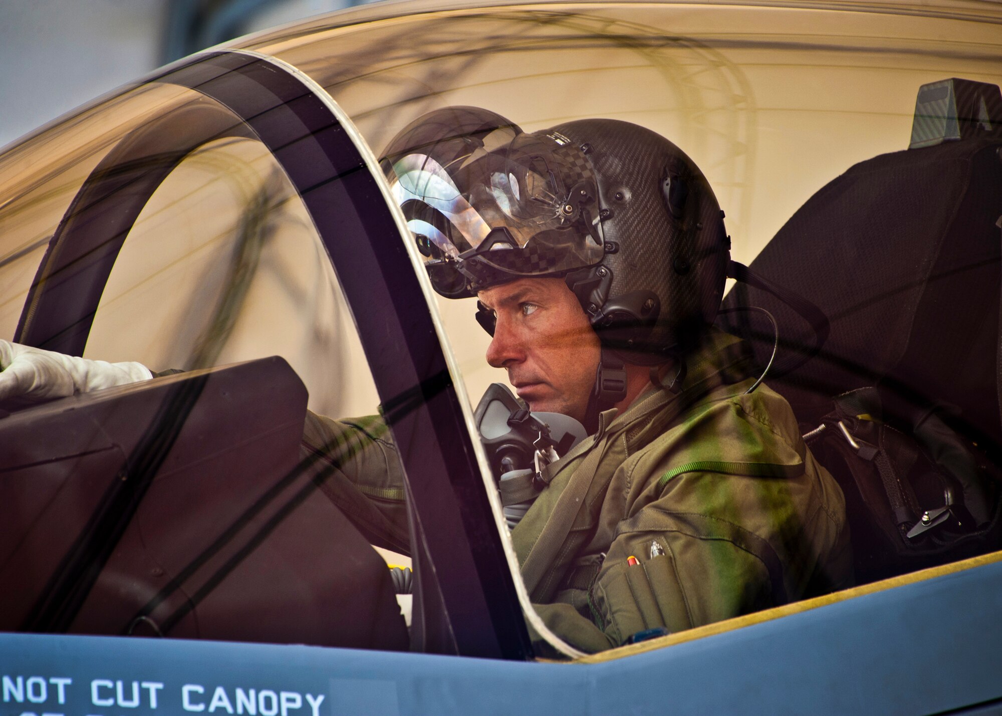 Marine Maj. Joseph Bachmann, of the 33rd Operations Group, watches his crew chief during aircraft shutdown procedures of the second F-35 Lightning II joint strike fighter to arrive at Eglin Air Force Base, Fla., July 20.  Bachmann is the first Marine pilot to be JSF certified.  Aircraft AF-8 is the flagship for the 58th Fighter Squadron.  (U.S. Air Force photo/Samuel King Jr.)