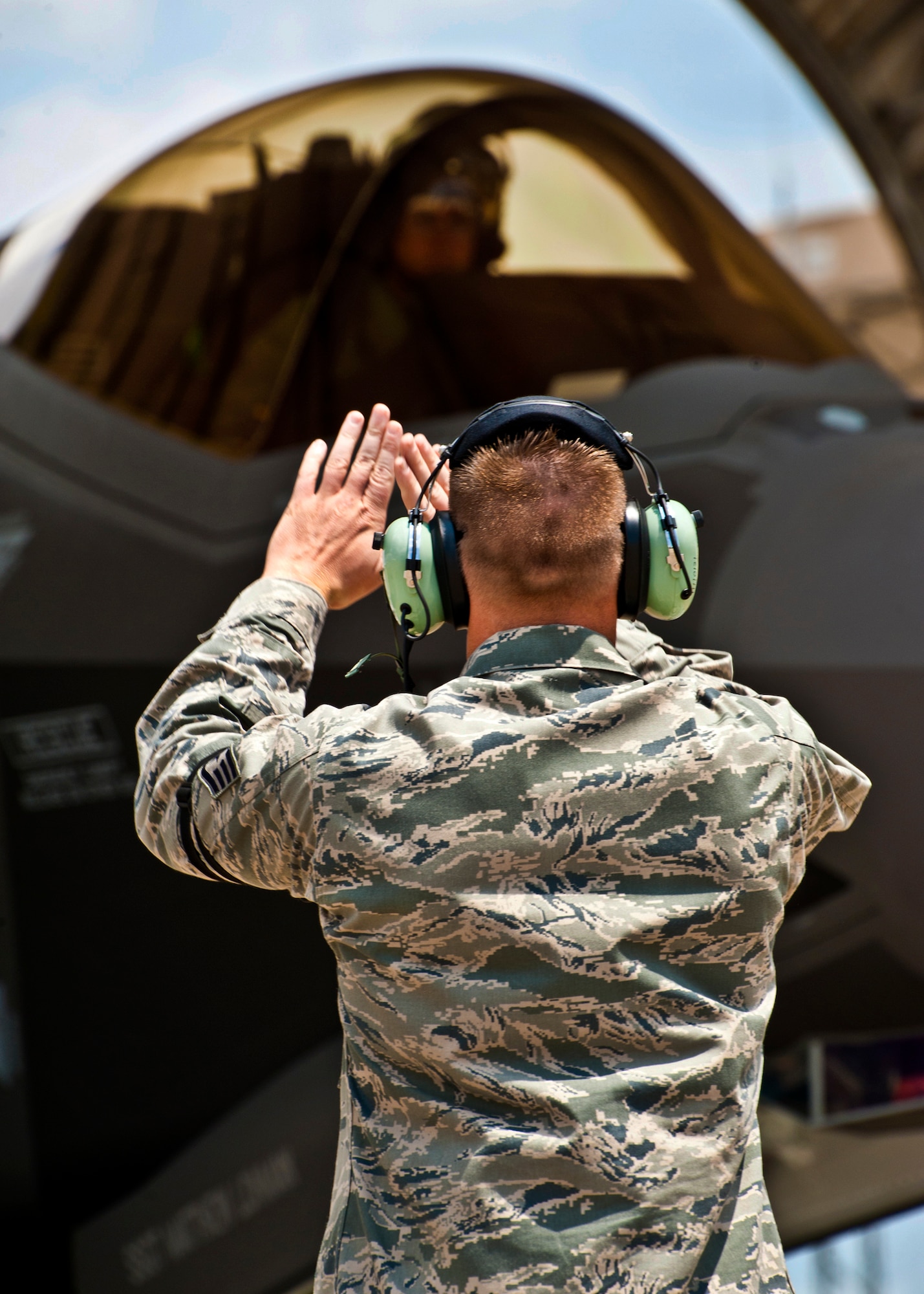 Staff Sgt. Matthew Lohman, of the 33rd Aircraft Maintenance Squadron, marshals in the second F-35 Lightning II joint strike fighter to arrive at Eglin Air Force Base, Fla., July 20.  The pilot, Maj. Joseph Bachmann, of the 33rd Operations Group, is the first Marine pilot to be JSF certified. Aircraft AF-8 is the flagship for the 58th Fighter Squadron. (U.S. Air Force photo/Samuel King Jr.)