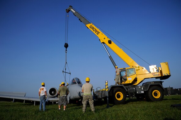 WHITEMAN AIR FORCE BASE, Mo. -- Members from the 442nd Fighter Wing, 509th Bomb Wing and 131st Bomb Wing work together to lift an A-10 Thunderbolt II here June 30, 2011. Crash recovery teams from Active Duty, Guard and Reserve units were called on-scene after the aircraft landed in the grass just beyond the runway. (U.S. Air Force photo by Airman 1st Class  Cody H. Ramirez)