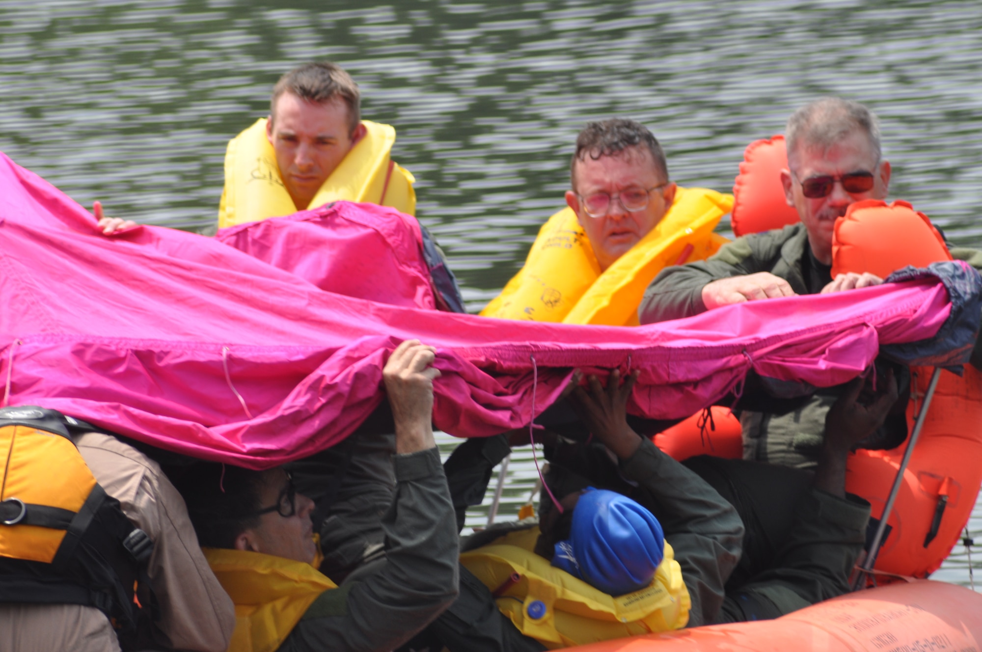 Members of the 908th Airlift Wing set up a 20-man life raft during recent water survival training in the Alabama River.
