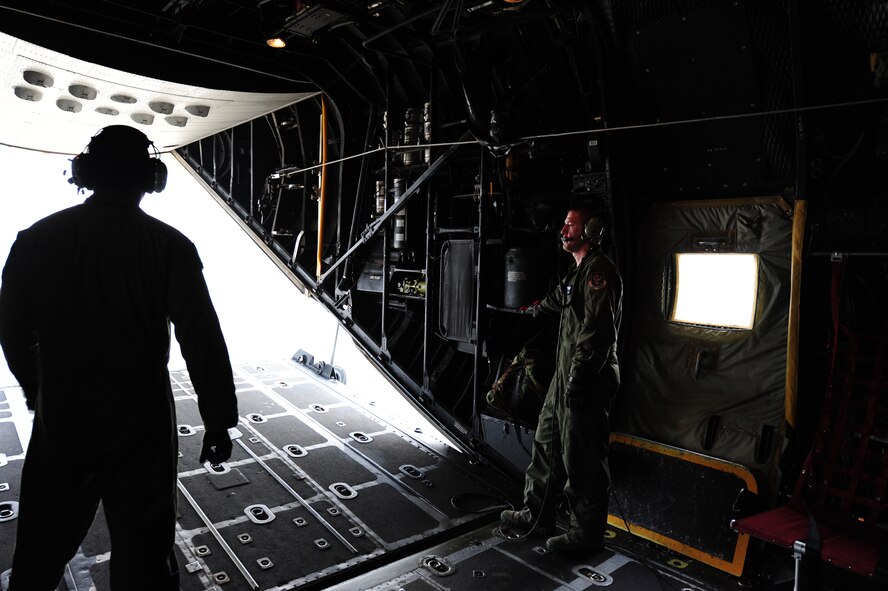 U.S. Air Force Airman 1st Class Barret Smith (right) and Tech. Sgt. Alfert Anderson, 71st Rescue Squadron loadmasters, watch the cargo door of an HC-130 Combat King close before takeoff at Moody Air Force Base, Ga., July 12, 2011. Loadmasters plan the placement of cargo and passengers to keep the aircraft within permissible center of gravity limits throughout the flight. (U.S. Air Force photo by Senior Airman Stephanie Mancha/Released)