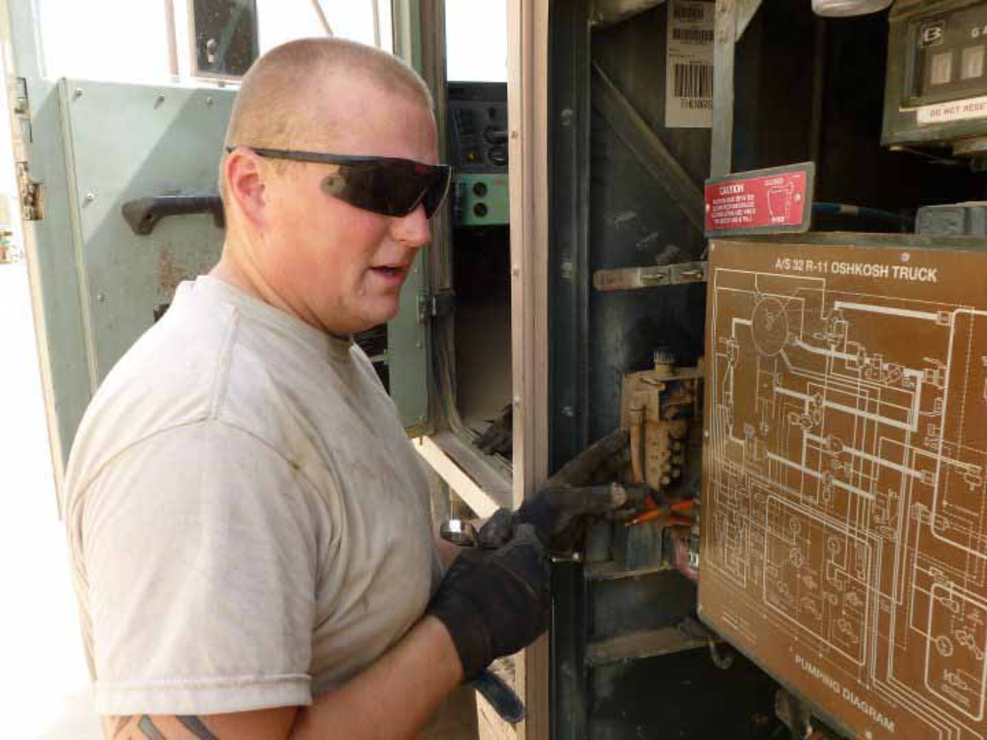 ALI AIR BASE, Iraq -- Senior Airman Matt Barker, 407th Air Expeditionary Support Squadron, works to bypass an air valve to get the R11 refueler back to the petroleum, oils and lubricants shop. Airman Barker departed Whiteman April 27and works as a special vehicle maintenance journeyman. (Courtesy photo) 