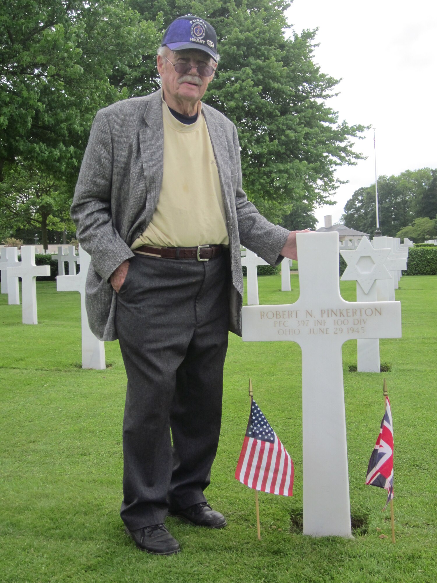 CAMBRIDGE AMERICAN CEMETERY, England - James Pinkerton, 87-year-old Purple Heart veteran of World War II, stands by his brother’s grave at Cambridge American Cemetery, May 19, 2011. Pinkerton visited his brother’s headstone to say a long-awaited ‘hello,’ and final ‘good bye.’ (Courtesy photo)